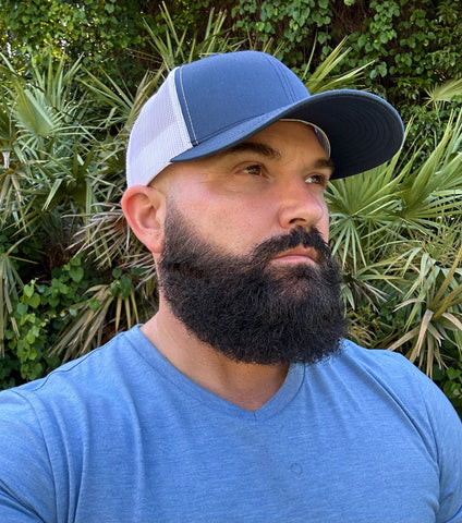Navy blue and white Dry-Core sweat-proof performance hat in black, designed with moisture-blocking technology, breathable fabric, and a sleek, structured fit for active wear. 